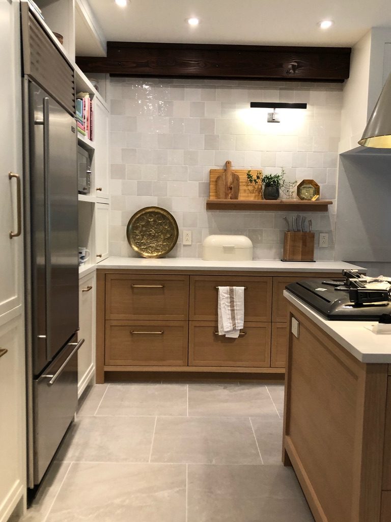 Contemporary kitchen with warm wood cabinetry, open shelving, and modern appliances, exemplifying elegant and functional interior design by Campo Design in Victoria, BC.