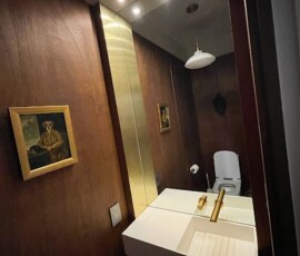 A bathroom with a sink and mirror in it