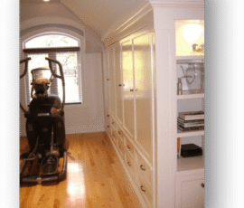 A room with a large window and a wooden floor