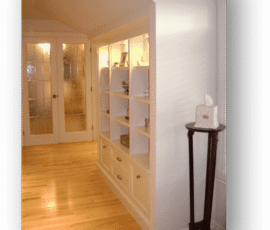 A room with many shelves and a floor lamp