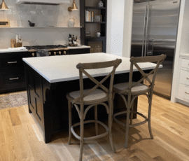 A kitchen with wooden floors and white counters.